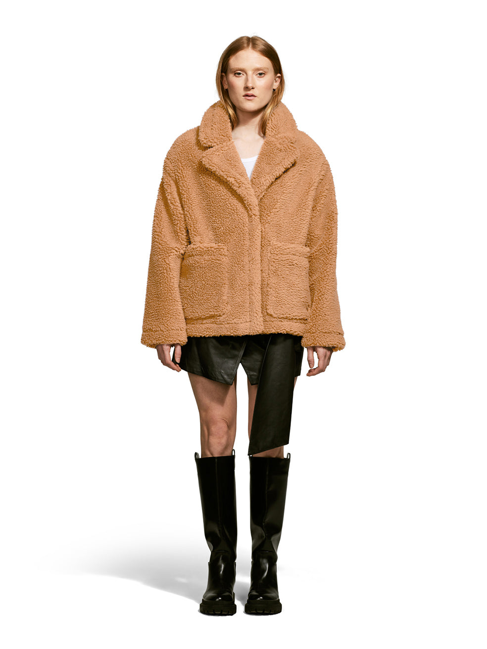 Model wearing the Robin, a hip-length teddy-inspired faux-fur sherpa shell in camel color from the front.