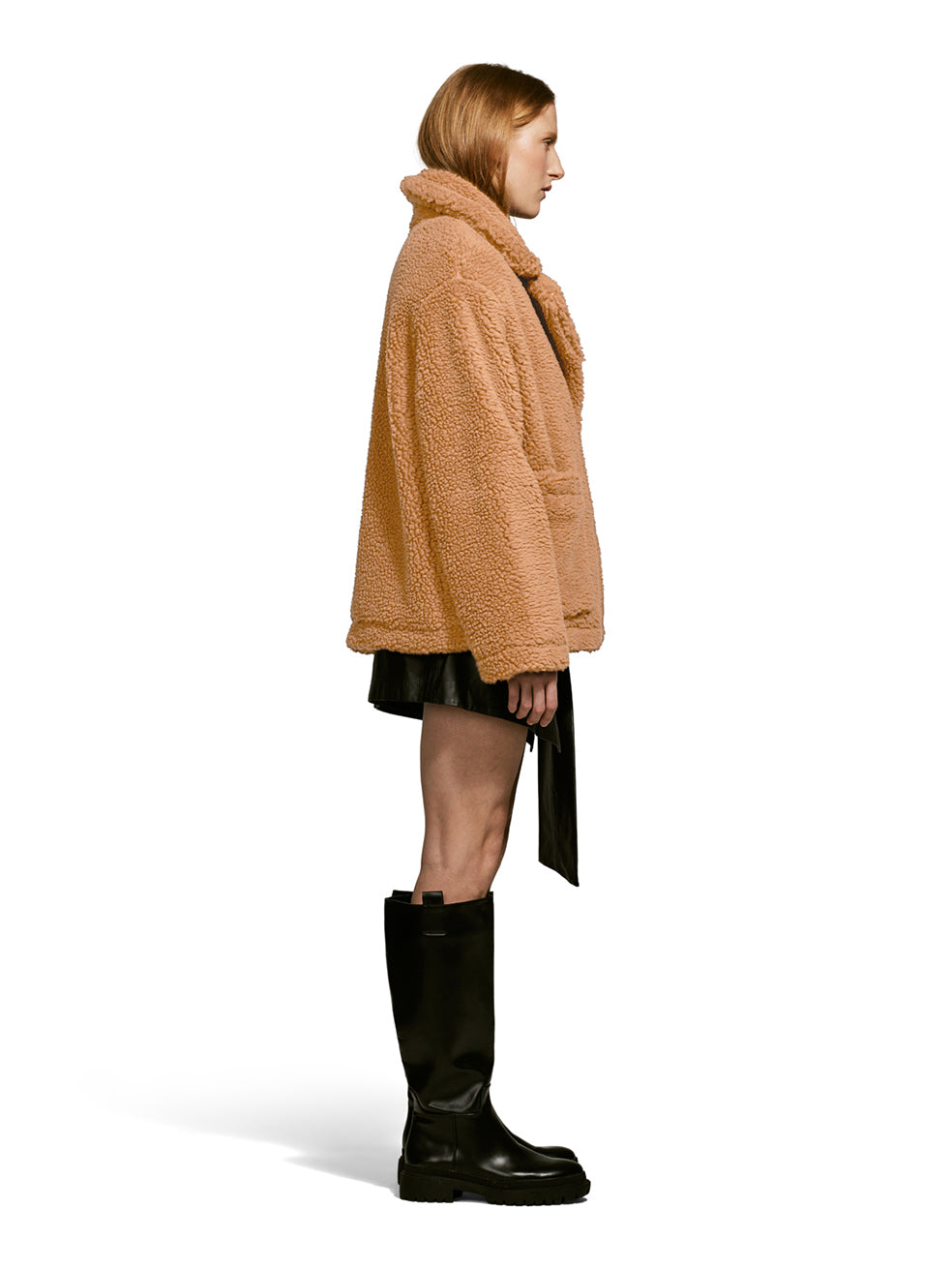 Model wearing the Robin, a hip-length teddy-inspired faux-fur sherpa shell in camel color from the front.