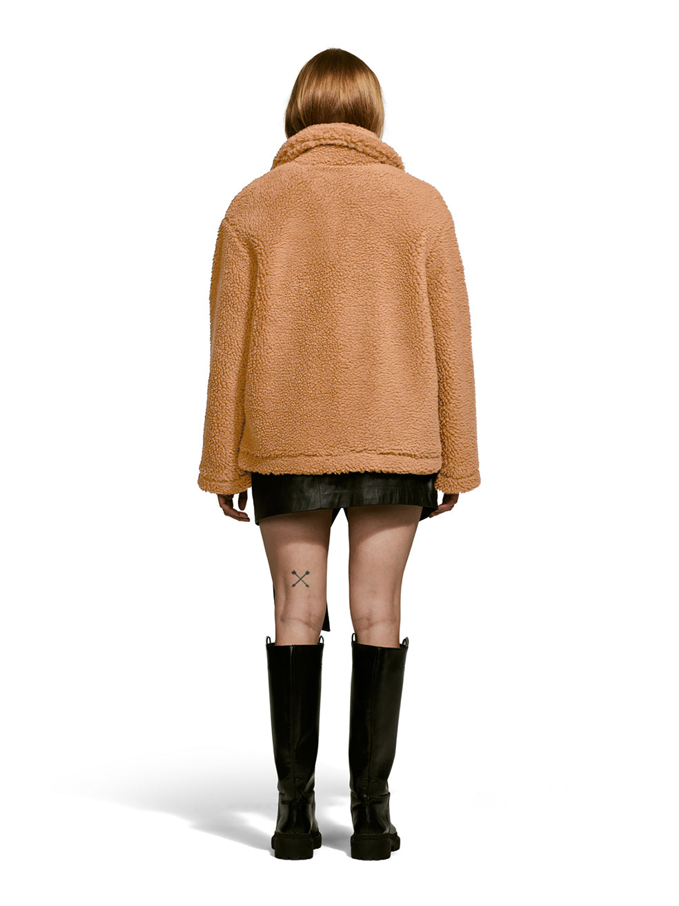 Model wearing the Robin, a hip-length teddy-inspired faux-fur sherpa shell in camel color from the rear.